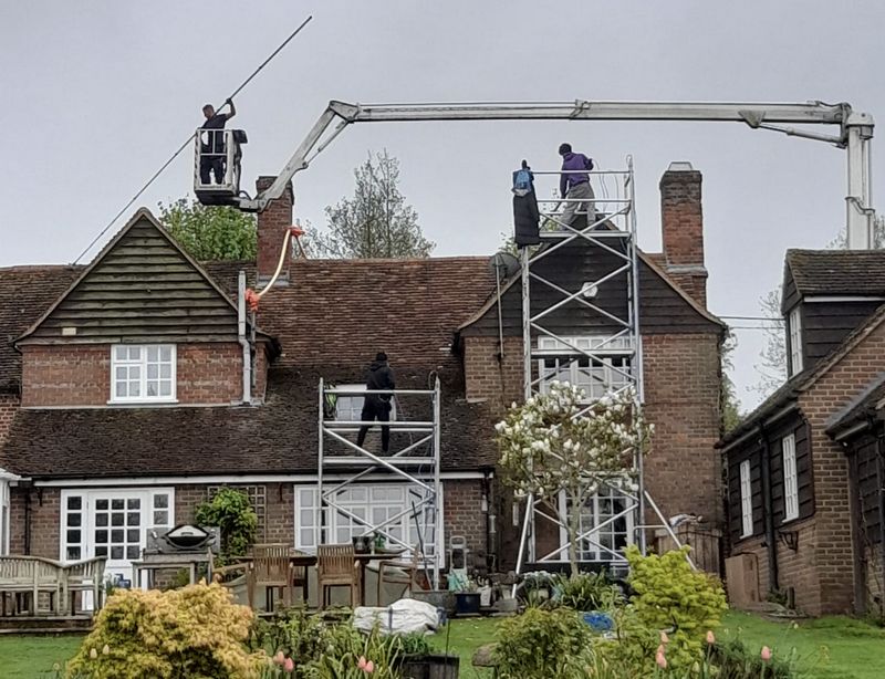 The Roof Moss Cleaners using cherry picker and scaffolding to clean roof safely and professionally in Cobham, Surrey